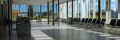 A shot of the boarding gates area at YGK Airport with an airline counter on the left and chairs on the far right.